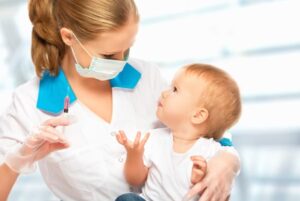 A doctor does injection child vaccination baby