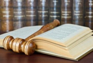 A law journal lays open with a gavel resting on a page.
