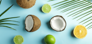 Coconuts, lemons, and limes on a blue surface. Dehydration in kids.