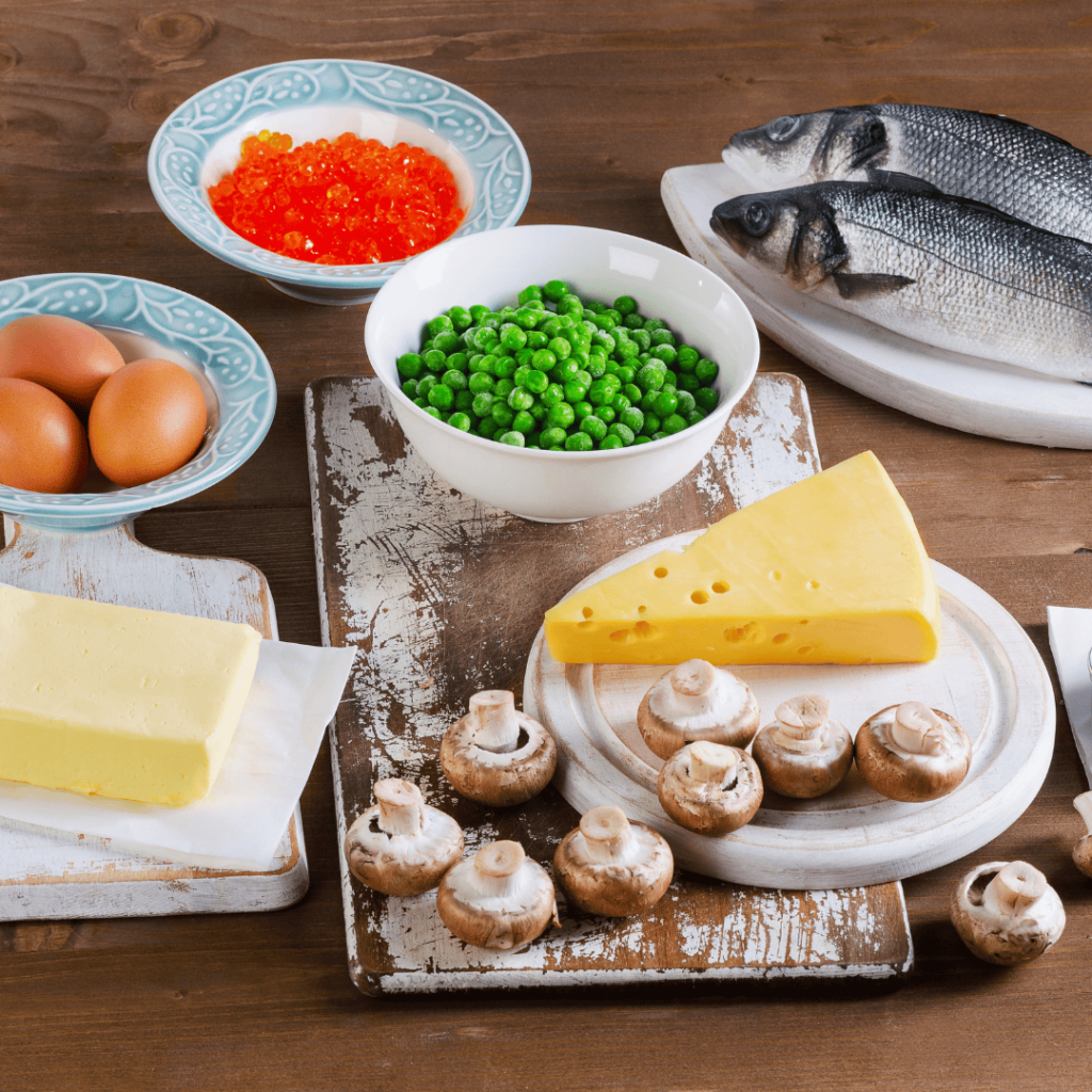 A variety of foods high In Vitamin A, including peas, cheese, eggs, butter, and mushrooms. 