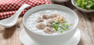 A bowl of congee sits on a kitchen table.
