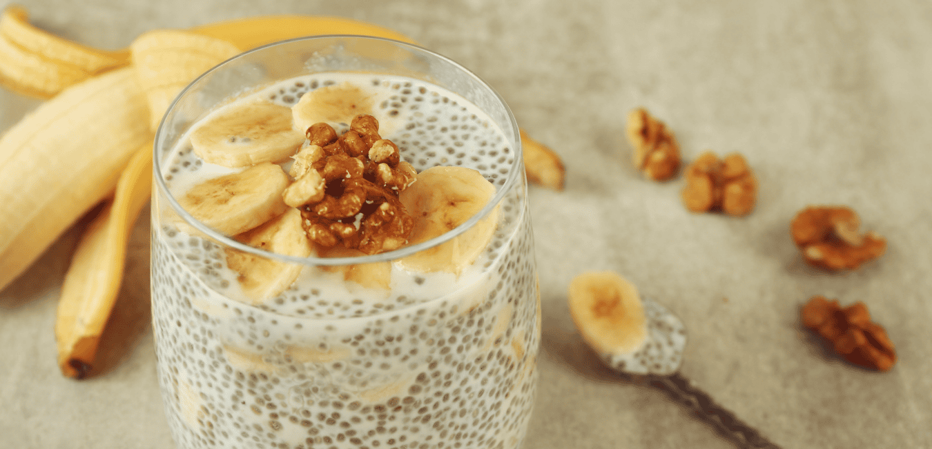 A bowl of chia pudding with bananas and nuts.