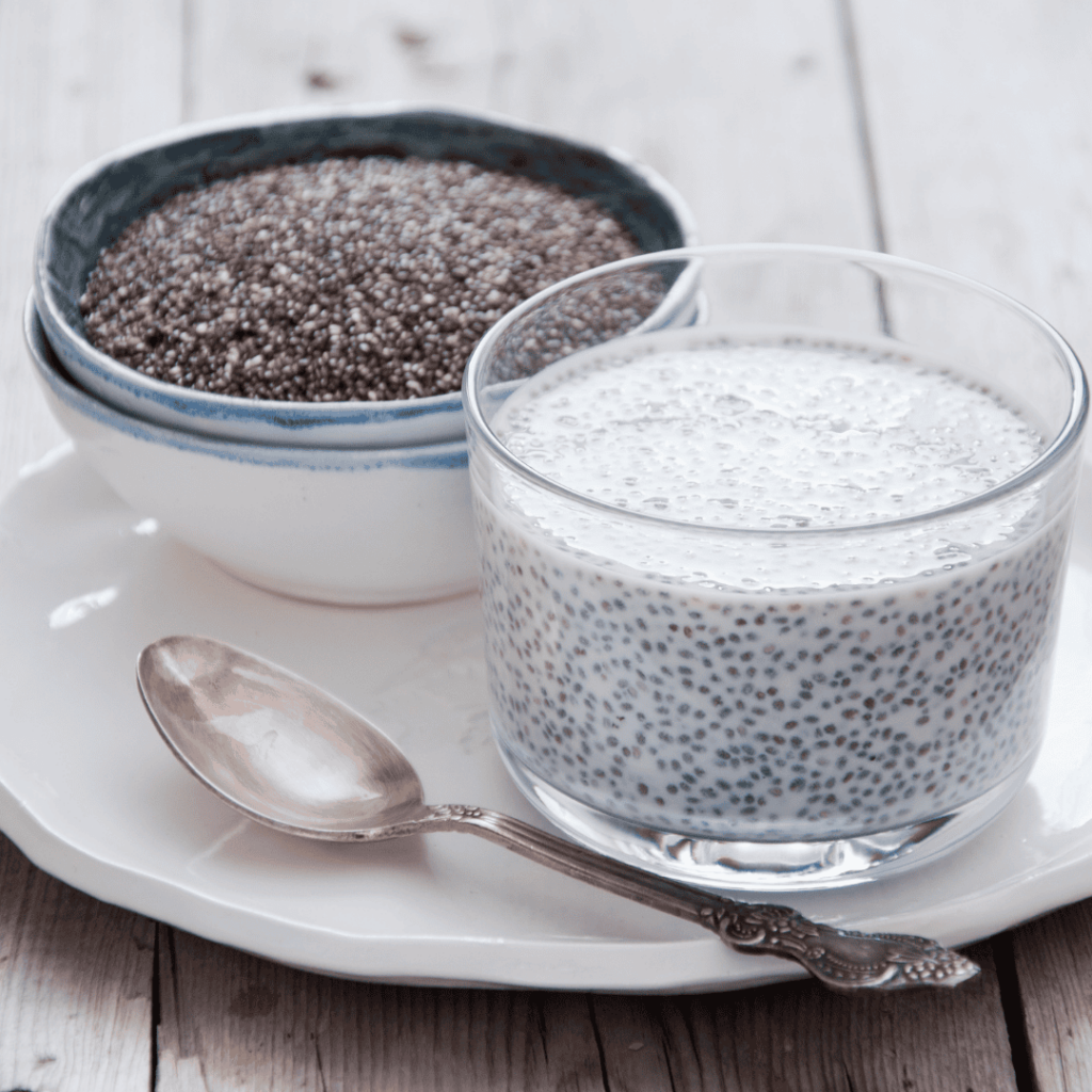 A bowl of chia seeds next to a bowl of chia pudding on a white plate. 
