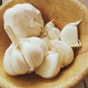 Garlic cloves in a wooden bowl.