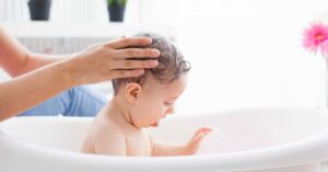 A child soaks in a healing oatmeal bath.