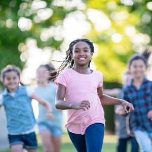 A group of kids runs outdoors.