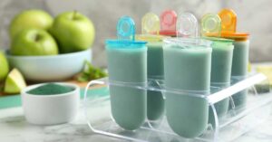 Healthy and hydrating homemade popsicles sit on a kitchen counter.