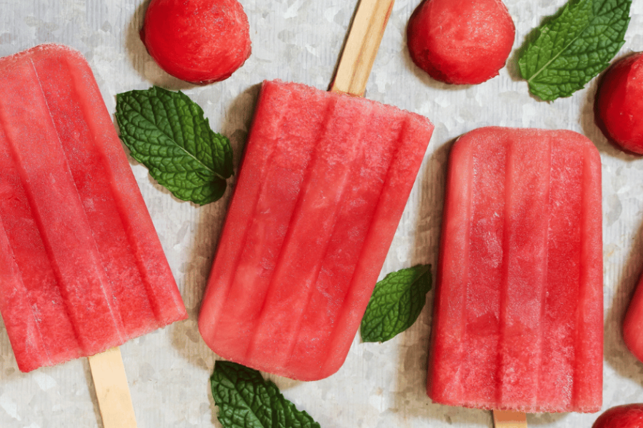 Hibiscus popsicles surrounded by green leaves.