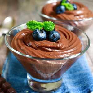 A glass bowl of healthy chocolate pudding.