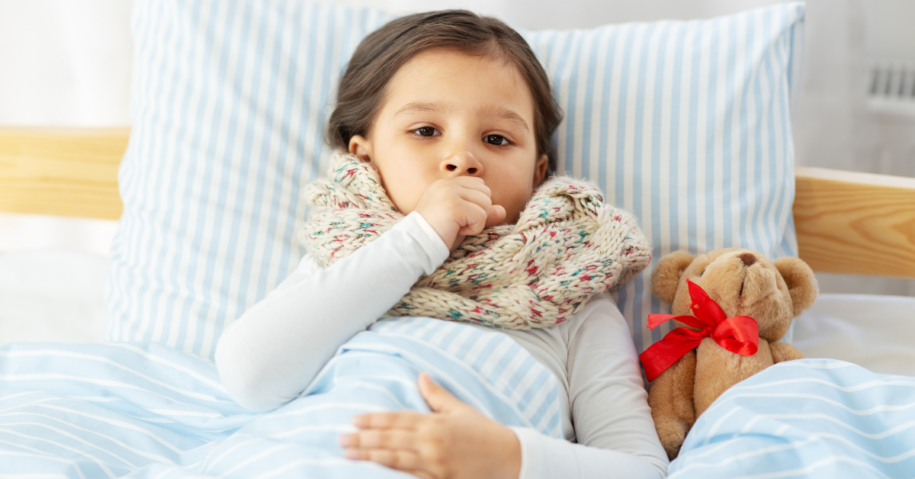 sick little girl in bed with her teddy bear