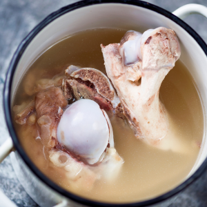 Bones and broth in a stockpot.