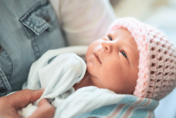 A new born baby gazes up at her mother.
