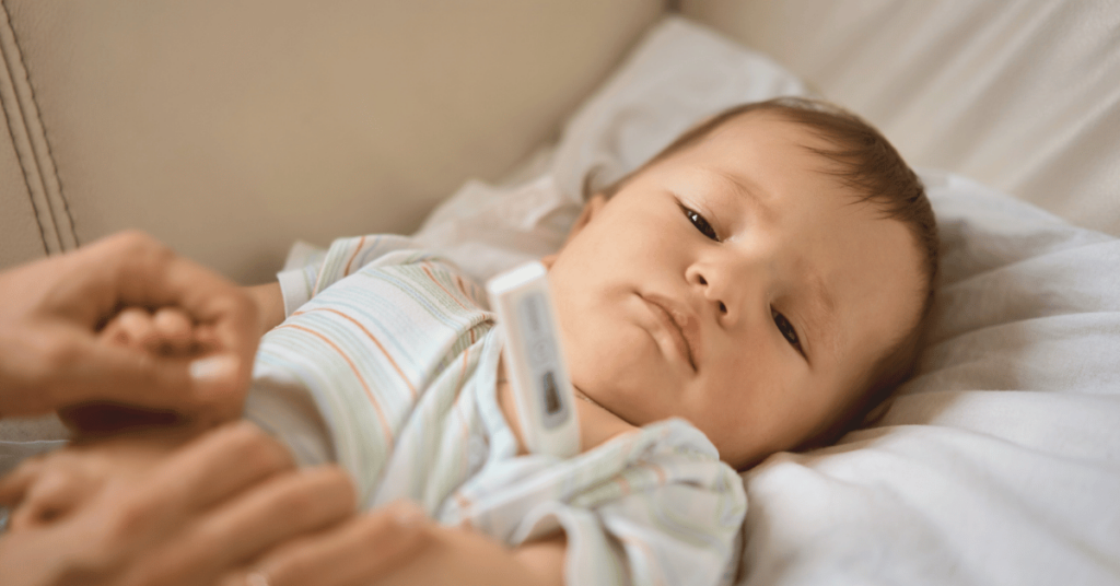 A sick baby gets their temperature taken.