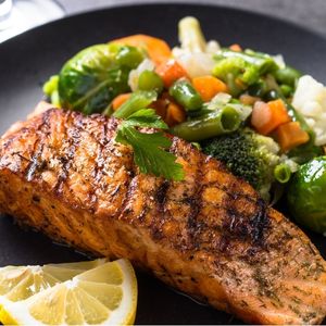 A plate of fish and steamed vegetables.