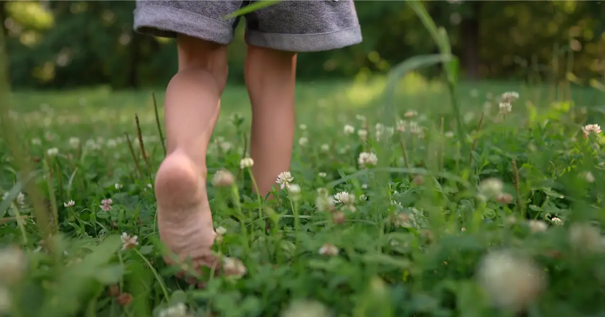 Kid walking barefoot in nature