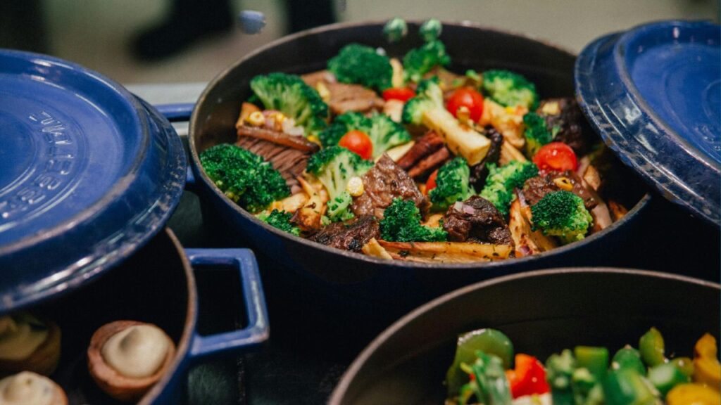 Dutch ovens on a stove full of nutritious food.