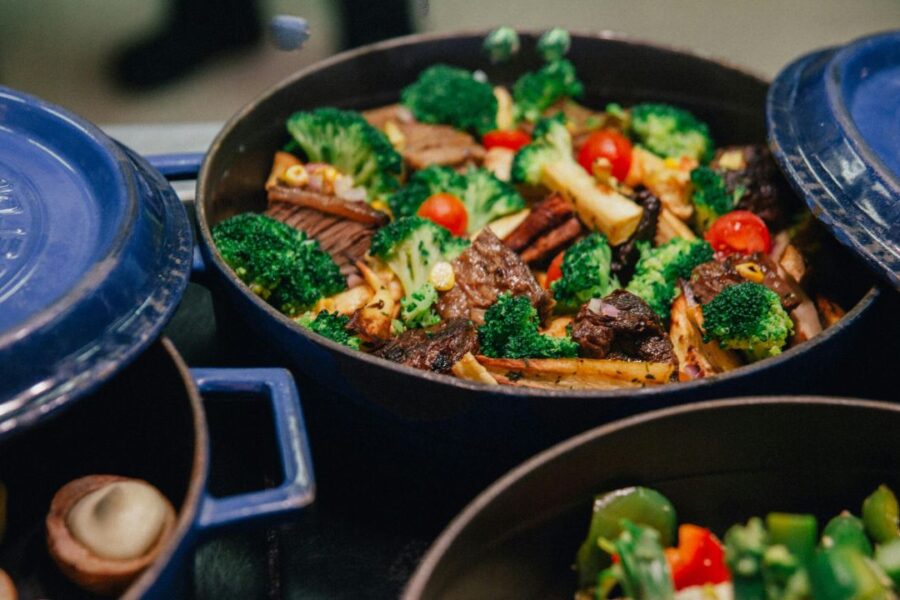 Dutch ovens on a stove full of nutritious food.