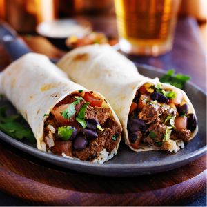 Two breakfast burritos on a plate.