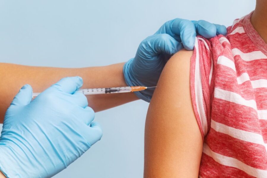 A child gets a vaccine in their arm.