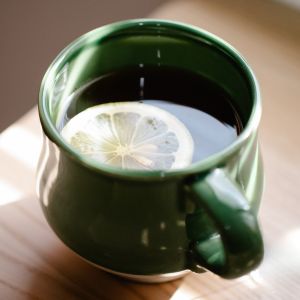 A soothing drink for coughs in a green mug.