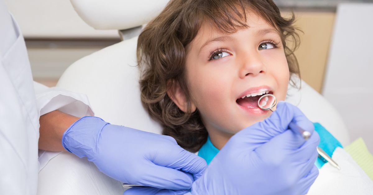 A young boy has his teeth checked by a dentist.