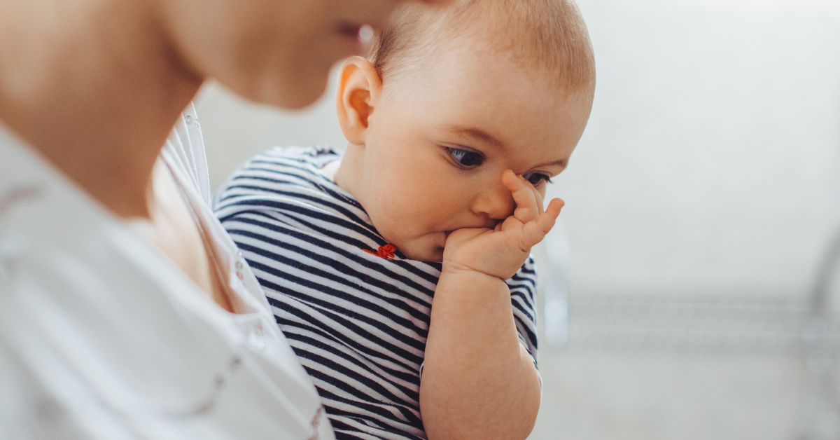 A baby is sucking his thumb.