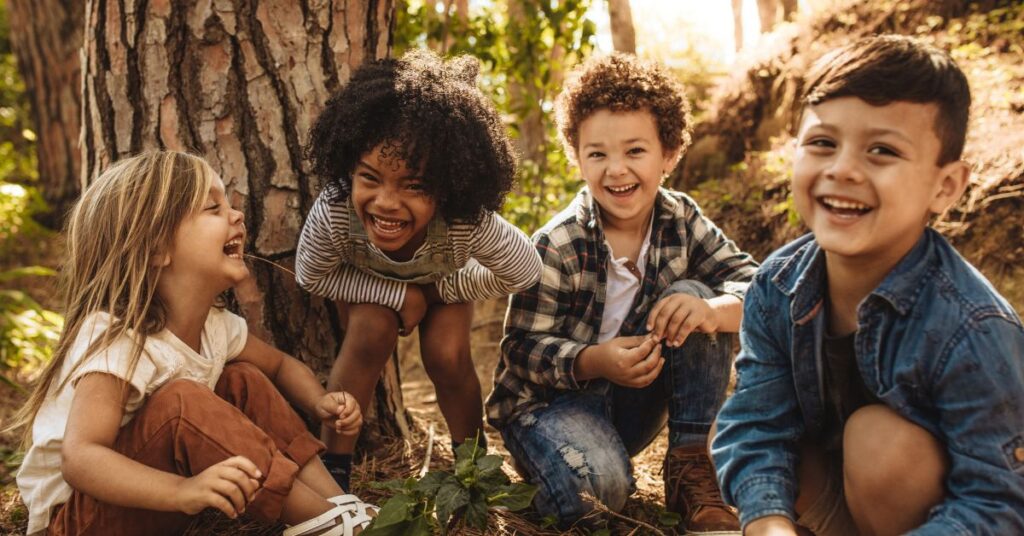 A group of kids plays in the woods.
