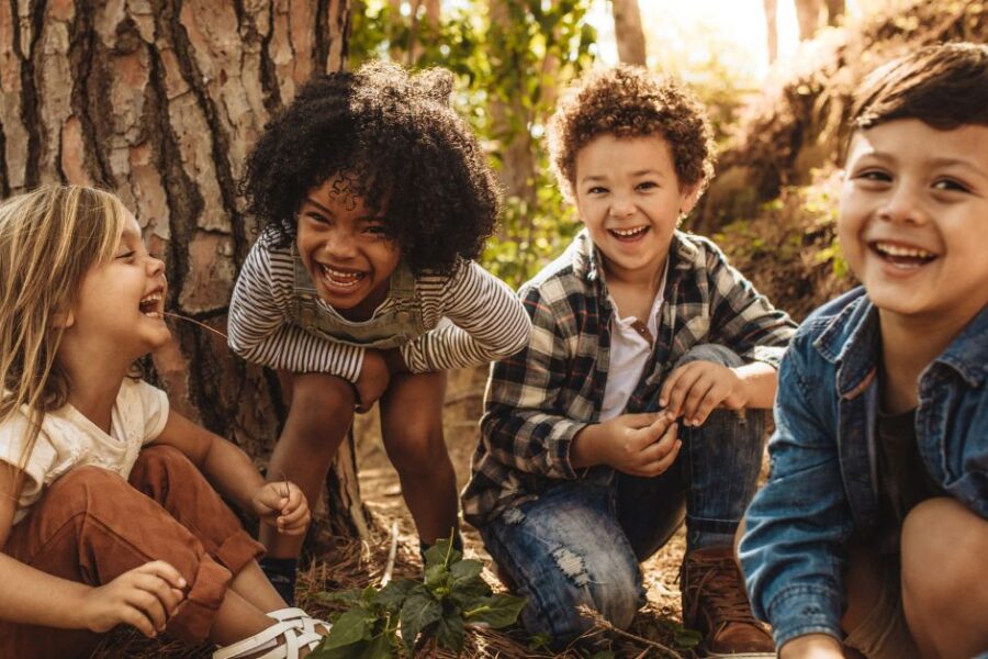 A group of kids plays in the woods.