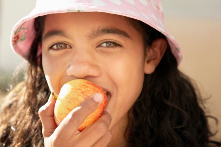 A girl eats an apple.