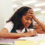 A stressed girl takes a test at school.