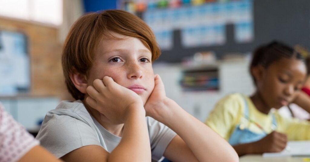 A boy stares off into space at school.
