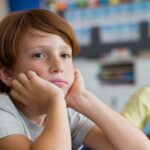 A boy stares off into space at school.
